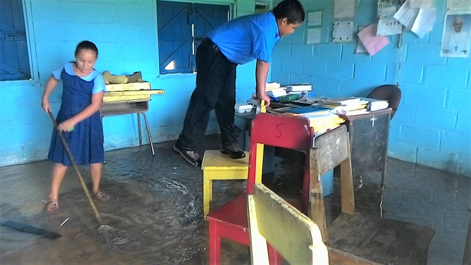 Students cleaning the flooding in the old St. Joseph building in Belize